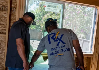 Two construction workers consulting over a project inside a building under construction.