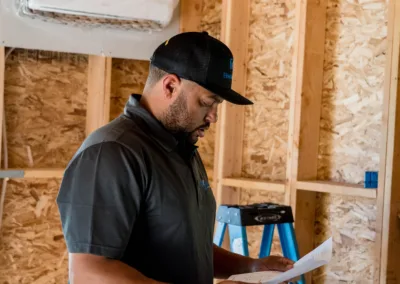 A man reviewing plans on a construction site.