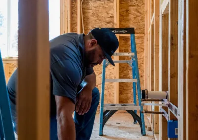 A construction worker reviews plans on a building site.