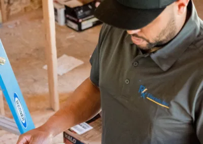 A construction worker reviewing blueprints on a construction site.