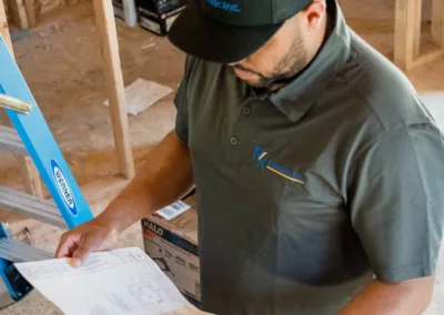 Construction worker reviewing plans at a building site.