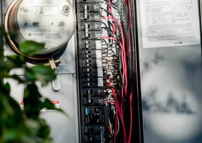 Electrical panel with wiring and a siemens label next to an analog meter.