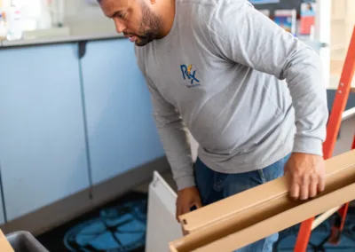 Man moving office equipment indoors.