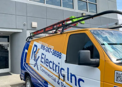 A commercial electrician's van parked in front of the teamsters union building.